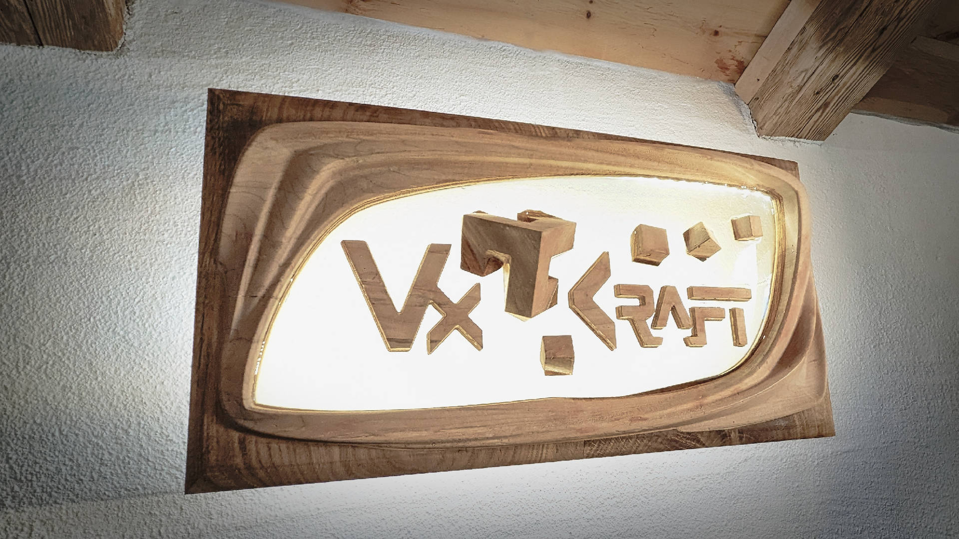 Photo of a backlit company sign made of a combination of three materials: oak, ash and epoxy window. The wooden logo seems to float in the transparent epoxy.