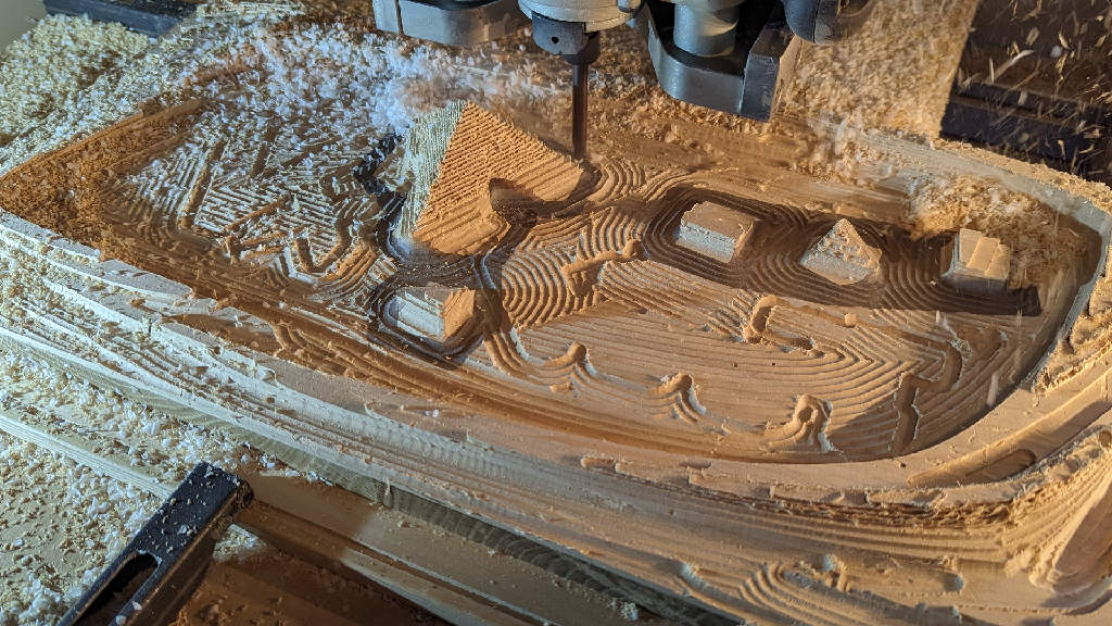 Photo of the milling (roughing) of an art object made of oak, ash and epoxy in the CNC machine.