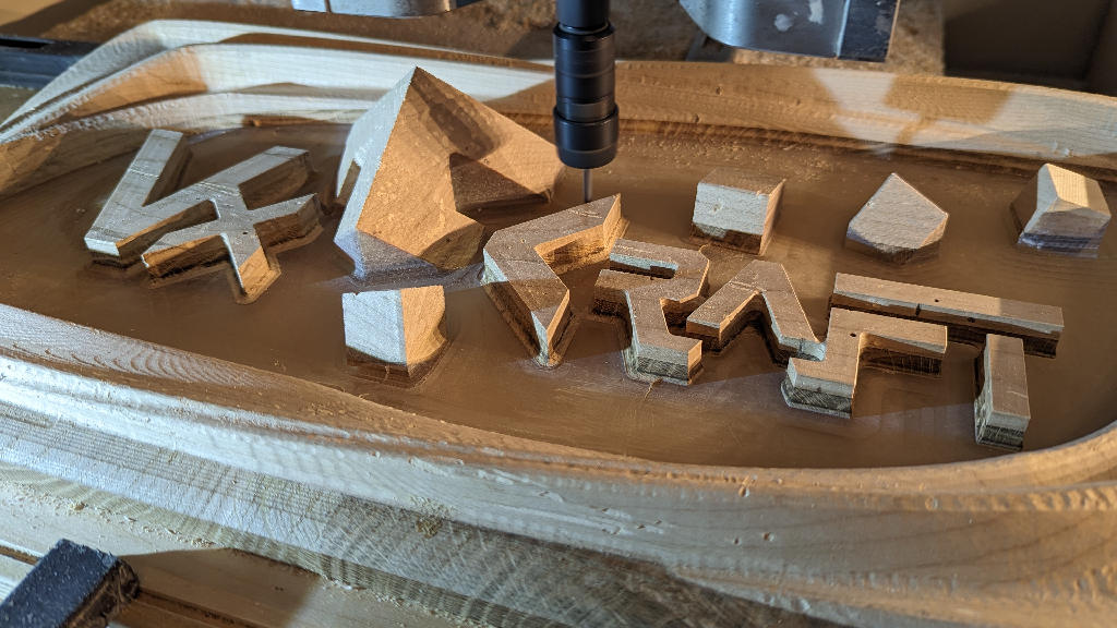 Photo of the milling (finishing) of an art object made of oak, ash and epoxy in the CNC machine.