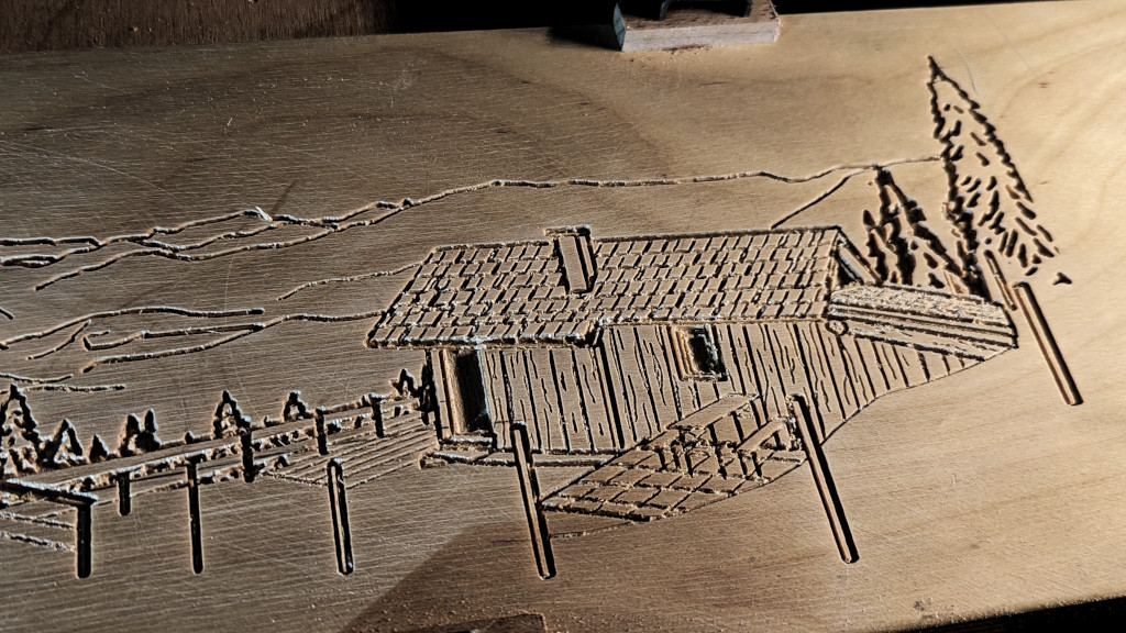 Closeup of an alpine hut engraved in a wooden plate.